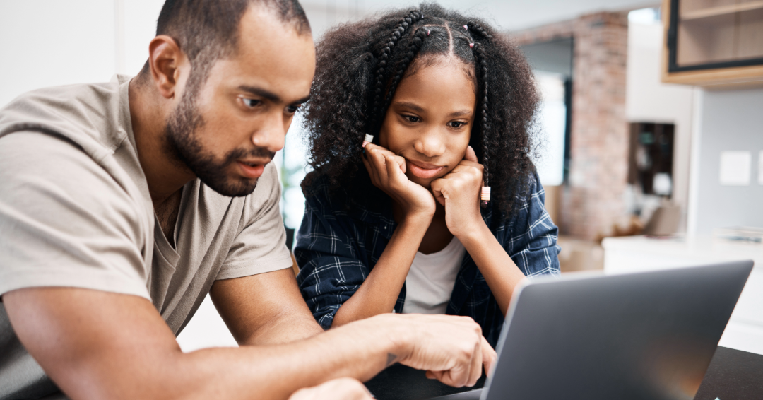 Father and daughter on laptop